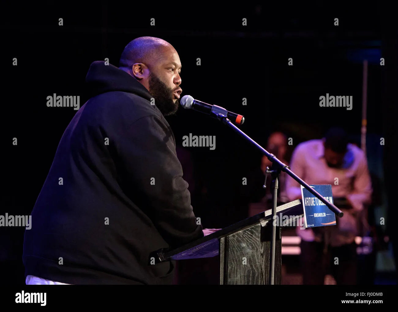 Rapper Killer Mike's 2024 Grammy Awards journey. On one side, the artist triumphantly stands on stage with three Grammy awards, symbolizing his musical achievements.