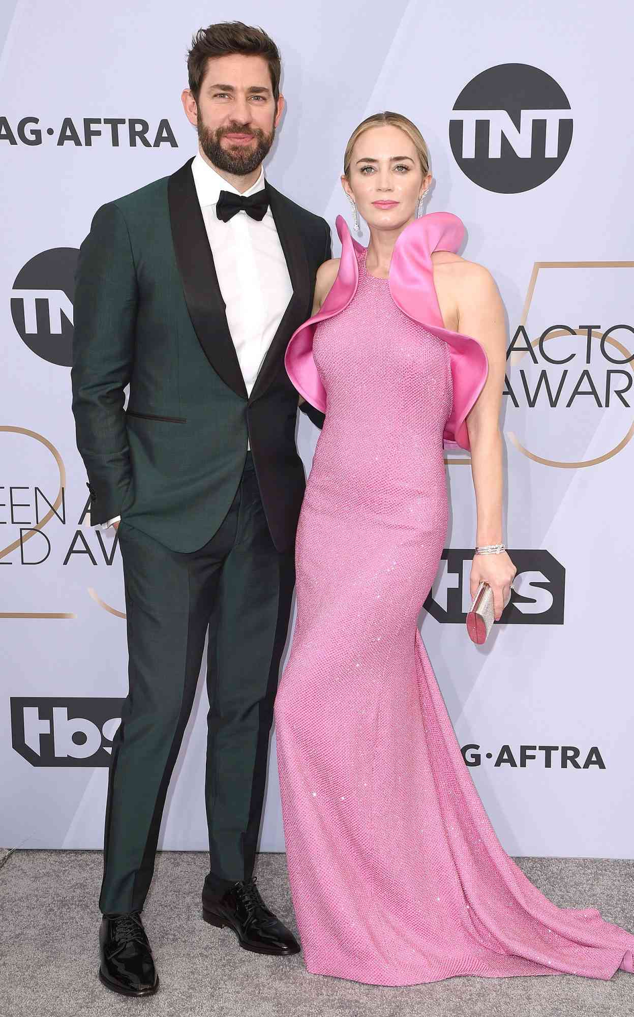 Emily Blunt and John Krasinski posing on the red carpet at the 2024 Academy Awards.