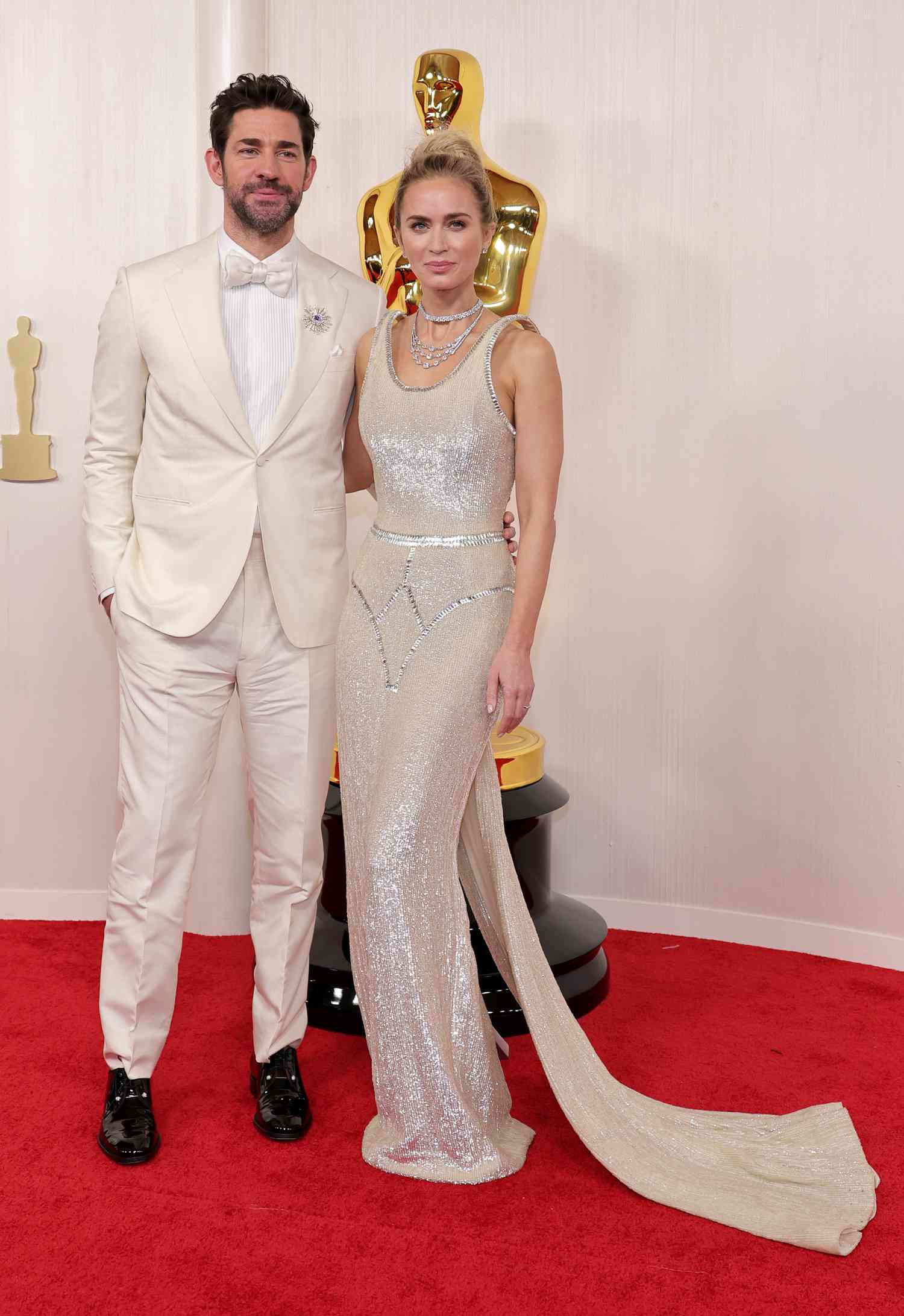 Emily Blunt and John Krasinski posing on the red carpet at the 2024 Academy Awards.