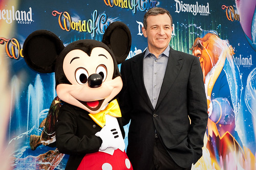 Bob Iger holding his 50-Year Service Award, a bronze statuette of Snow White and the Seven Dwarfs.