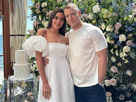 Olivia Culpo and Christian McCaffrey exchanging vows in the 150-year-old chapel in Watch Hill, Rhode Island.